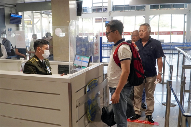 Travelers at Vietnam airport immigration counter presenting Vietnam visa requirements documents